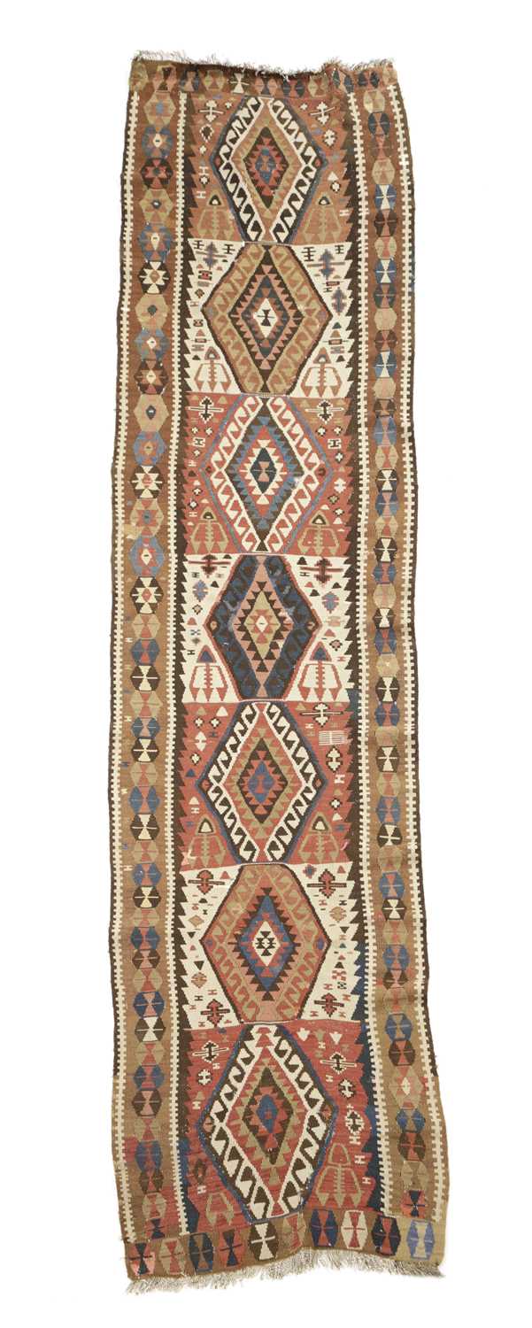 A TRIBAL KILIM RUNNER SOUTH WEST PERSIA, C.1900 the polychrome compartmentalised field with