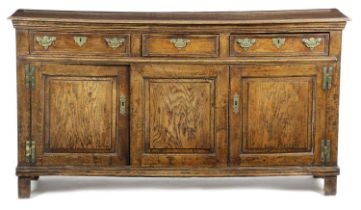 A CHARLES II OAK DRESSER C.1670-90 of narrow proportions, the moulded top with a plate rest above
