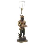 A BLACKAMOOR TABLE LAMP 20TH CENTURY the male figure standing before a brass lamp, wearing a