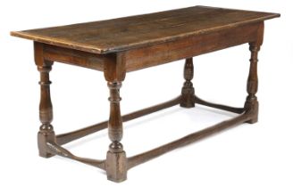 AN OAK REFECTORY TABLE LATE 17TH CENTURY AND LATER the boarded top with cleated ends, above a