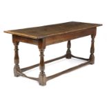 AN OAK REFECTORY TABLE LATE 17TH CENTURY AND LATER the boarded top with cleated ends, above a