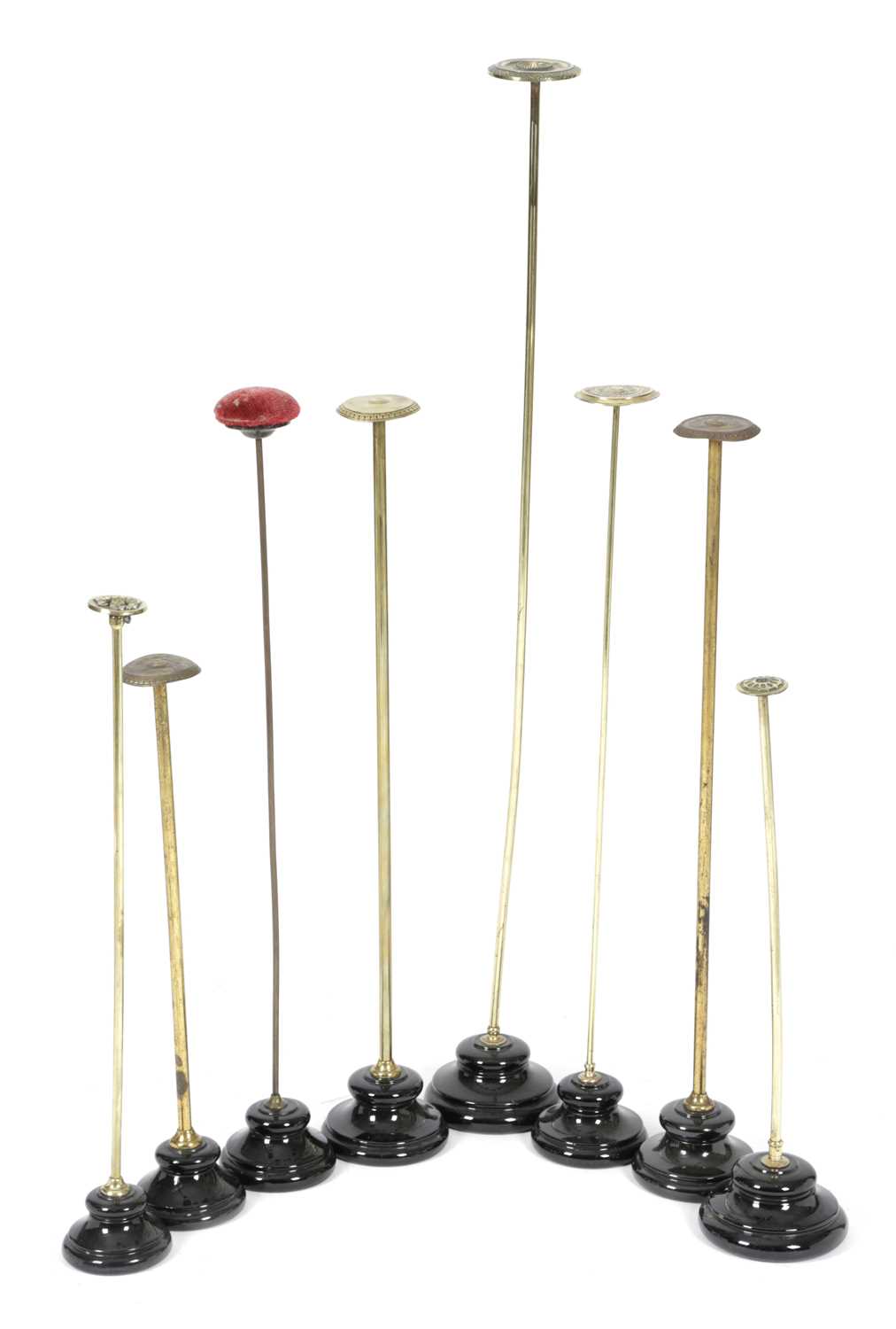 A COLLECTION OF EIGHT BRASS HAT OR SCARF STANDS EARLY 20TH CENTURY of various heights, on black