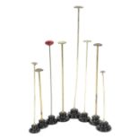 A COLLECTION OF EIGHT BRASS HAT OR SCARF STANDS EARLY 20TH CENTURY of various heights, on black