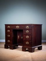 A GEORGE II MAHOGANY KNEEHOLE DESK MID-18TH CENTURY the caddy moulded edge top above an
