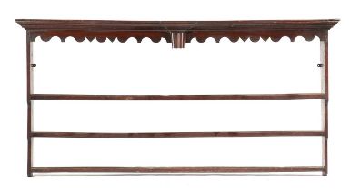 A GEORGE III OAK PLATE RACK C.1770 the moulded cornice above a shaped apron with a central