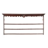 A GEORGE III OAK PLATE RACK C.1770 the moulded cornice above a shaped apron with a central