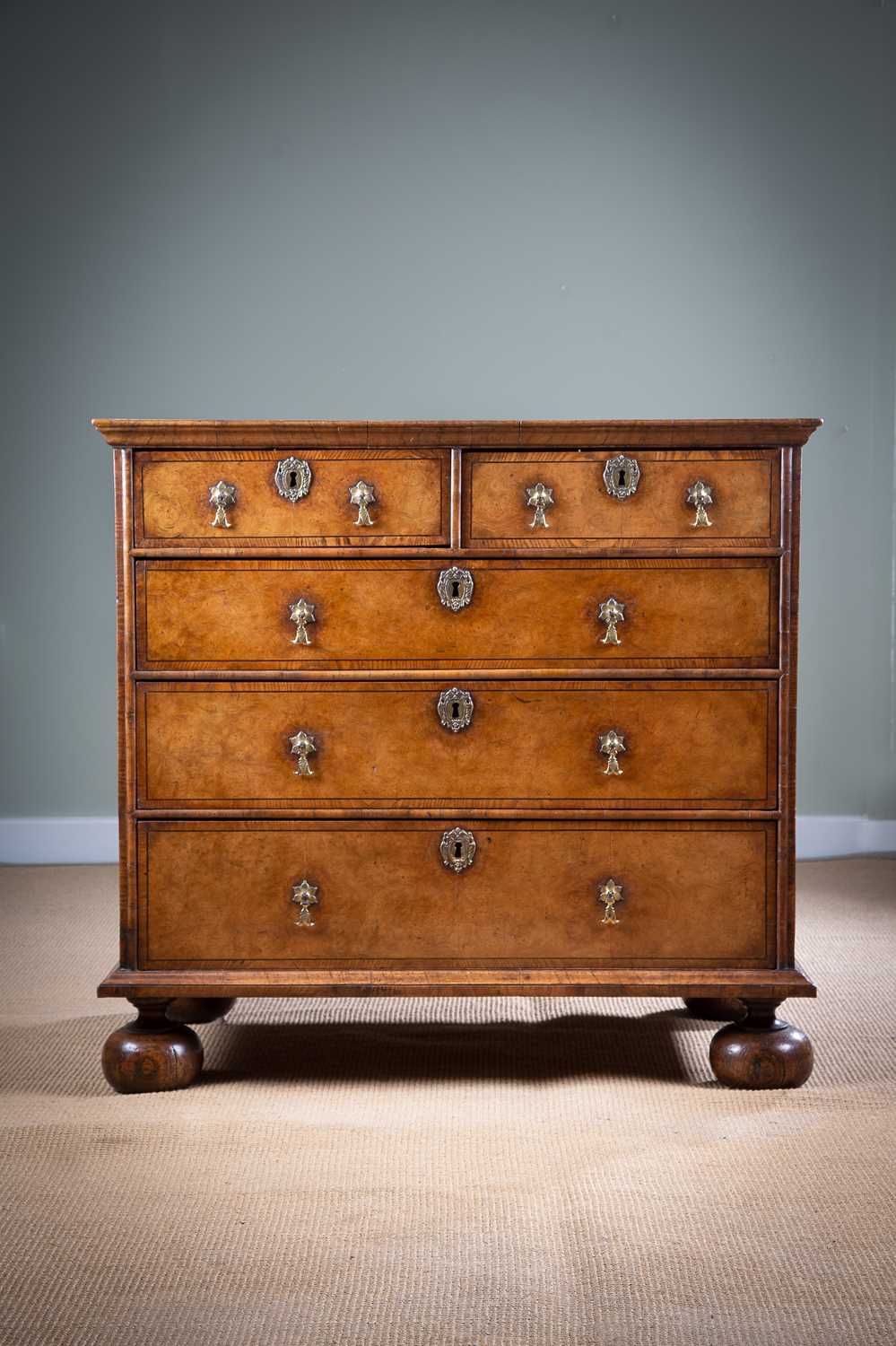 A WILLIAM AND MARY BURR ELM CHEST LATE 17TH / EARLY 18TH CENTURY with ash banding and ebonised