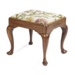 A GEORGE II WALNUT STOOL C.1740 the rectangular seat with floral embroidered upholstery above