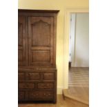 A GEORGE III OAK LIVERY CUPBOARD c.1760-70 with a pair of doors with Gothic ogee panels enclosing an