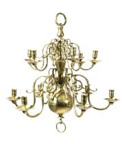 A DUTCH BRASS TWO-TIER TWELVE LIGHT CHANDELIER IN 18TH CENTURY STYLE with a turned stem