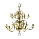 A DUTCH BRASS TWO-TIER TWELVE LIGHT CHANDELIER IN 18TH CENTURY STYLE with a turned stem