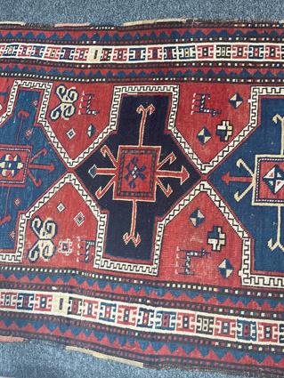 A KAZAK RUG CENTRAL CAUCASUS, C.1890 the madder field with four linked panels of hooked motifs - Image 3 of 5