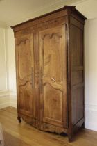 A FRENCH PROVINCIAL CHERRYWOOD ARMOIRE LATE 18TH CENTURY the moulded cornice above a frieze with