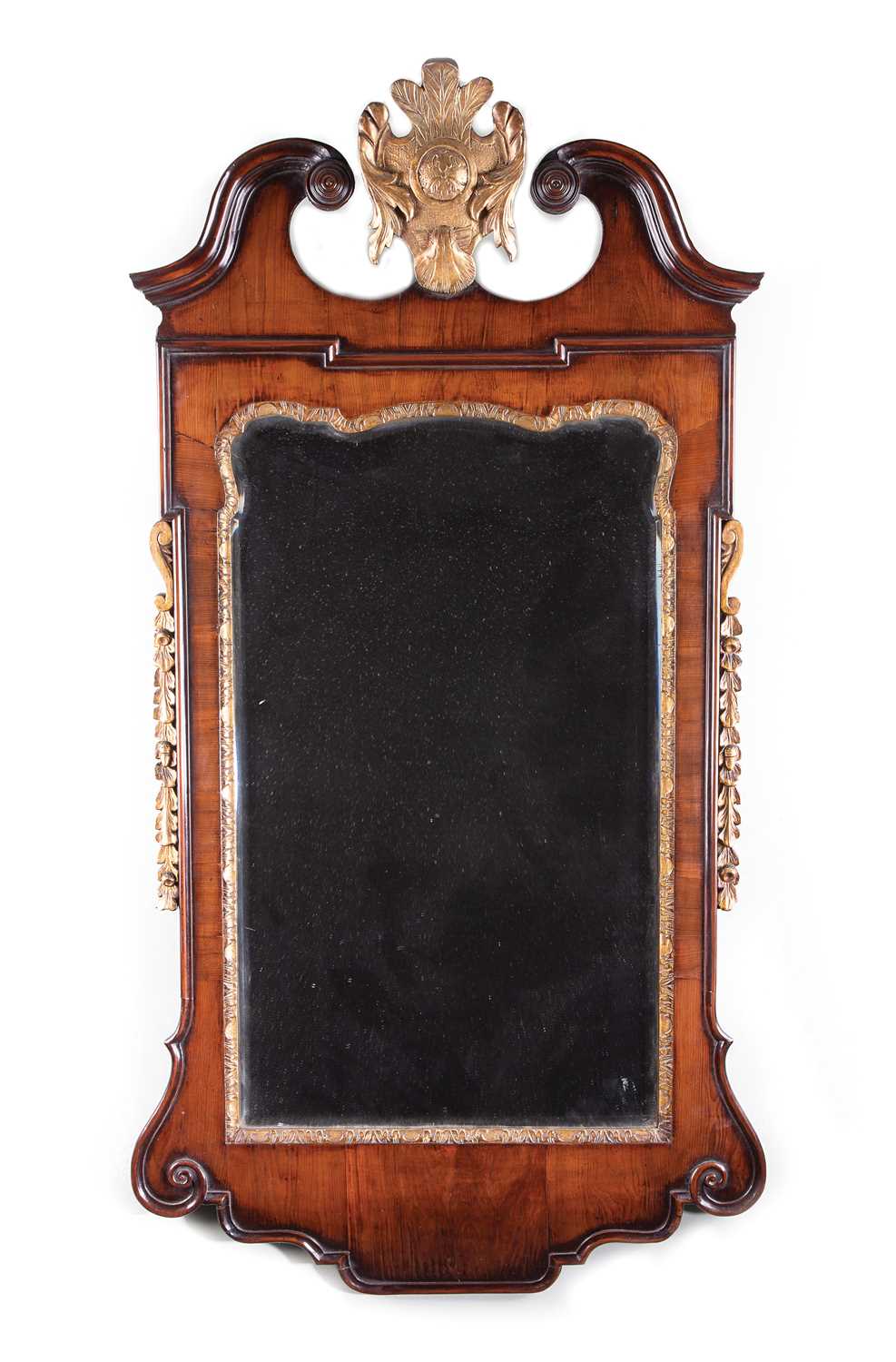 A RARE GEORGE II YEW AND GILTWOOD MIRROR C.1735 the later bevelled, shaped rectangular plate