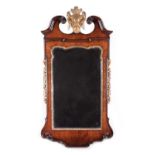 A RARE GEORGE II YEW AND GILTWOOD MIRROR C.1735 the later bevelled, shaped rectangular plate