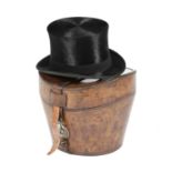 A BROWN LEATHER HAT BOX AND SILK TOP HAT LATE 19TH / EARLY 20TH CENTURY with a quilted interior, the