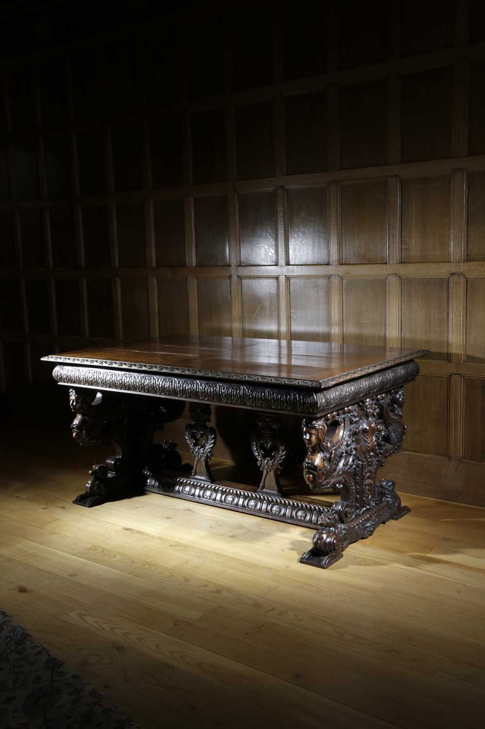 AN ITALIAN WALNUT DRAW-LEAF DINING TABLE IN RENAISSANCE STYLE, IN THE MANNER OF ANGIOLIO BARBETTI (