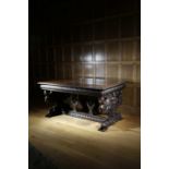AN ITALIAN WALNUT DRAW-LEAF DINING TABLE IN RENAISSANCE STYLE, IN THE MANNER OF ANGIOLIO BARBETTI (