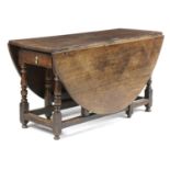 AN OAK OVAL GATELEG DINING TABLE EARLY 18TH CENTURY AND LATER with a single drawer on block and