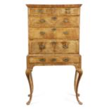 A WALNUT CHEST ON STAND EARLY 18TH CENTURY AND LATER with cross and feather banding and fitted