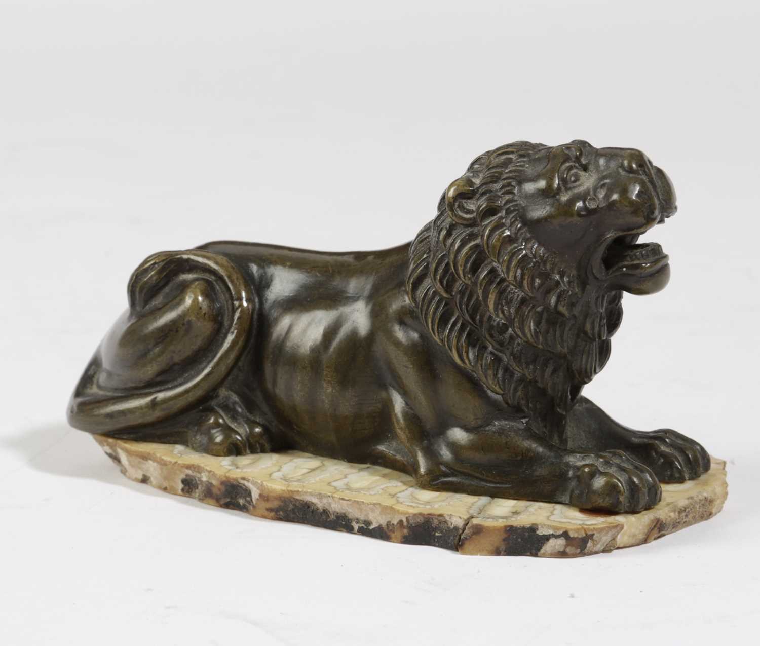 A FRENCH BRONZE MODEL OF A RECUMBENT LION EARLY 19TH CENTURY later mounted on a slice of mammoth - Image 2 of 2