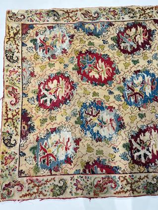A EUROPEAN NEEDLEPOINT RUG C.1900 the pale wheat field with polychrome rondels enclosed by floral - Image 5 of 7
