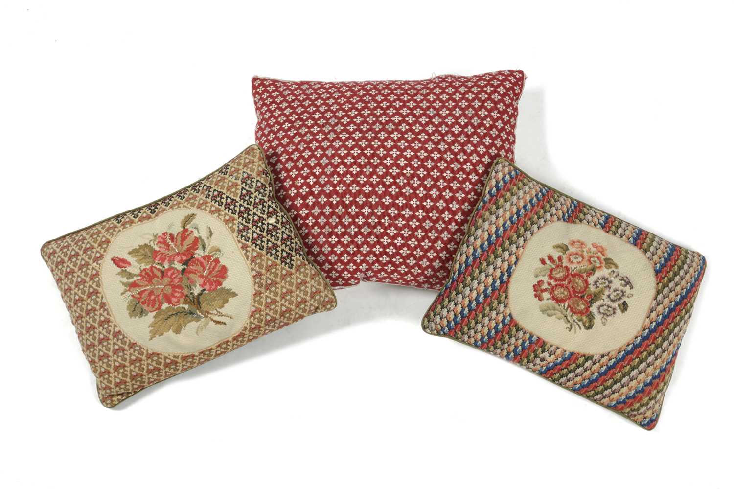 TWO NEEDLEWORK CUSHIONS each worked with sprays of flowers, together with another cushion (3) 49cm