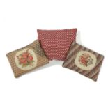 TWO NEEDLEWORK CUSHIONS each worked with sprays of flowers, together with another cushion (3) 49cm