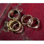 A GROUP OF FIVE GOLD RINGS including: a twisted gold ring, size M 1/2, an interlocking three