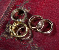 A GROUP OF FIVE GOLD RINGS including: a twisted gold ring, size M 1/2, an interlocking three