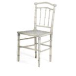 A PAINTED FAUX BAMBOO SIDE CHAIR IN REGENCY STYLE, POSSIBLY BY COLEFAX & FOWLER with a cane seat