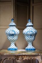 A PAIR OF FAUX DELFT PAINTED FIBREGLASS VASES AND COVERS ATTRIBUTED TO JOHN FOWLER, COLEFAX &
