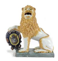 A DELFT POTTERY FIGURE OF A HERALDIC LION 19TH CENTURY seated on his haunches with one paw resting