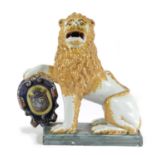 A DELFT POTTERY FIGURE OF A HERALDIC LION 19TH CENTURY seated on his haunches with one paw resting