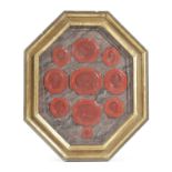 TEN RED WAX SEALS 20TH CENTURY depicting various classical subjects mounted in marble painted