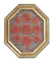 TEN RED WAX SEALS 20TH CENTURY depicting various classical subjects mounted in marble painted