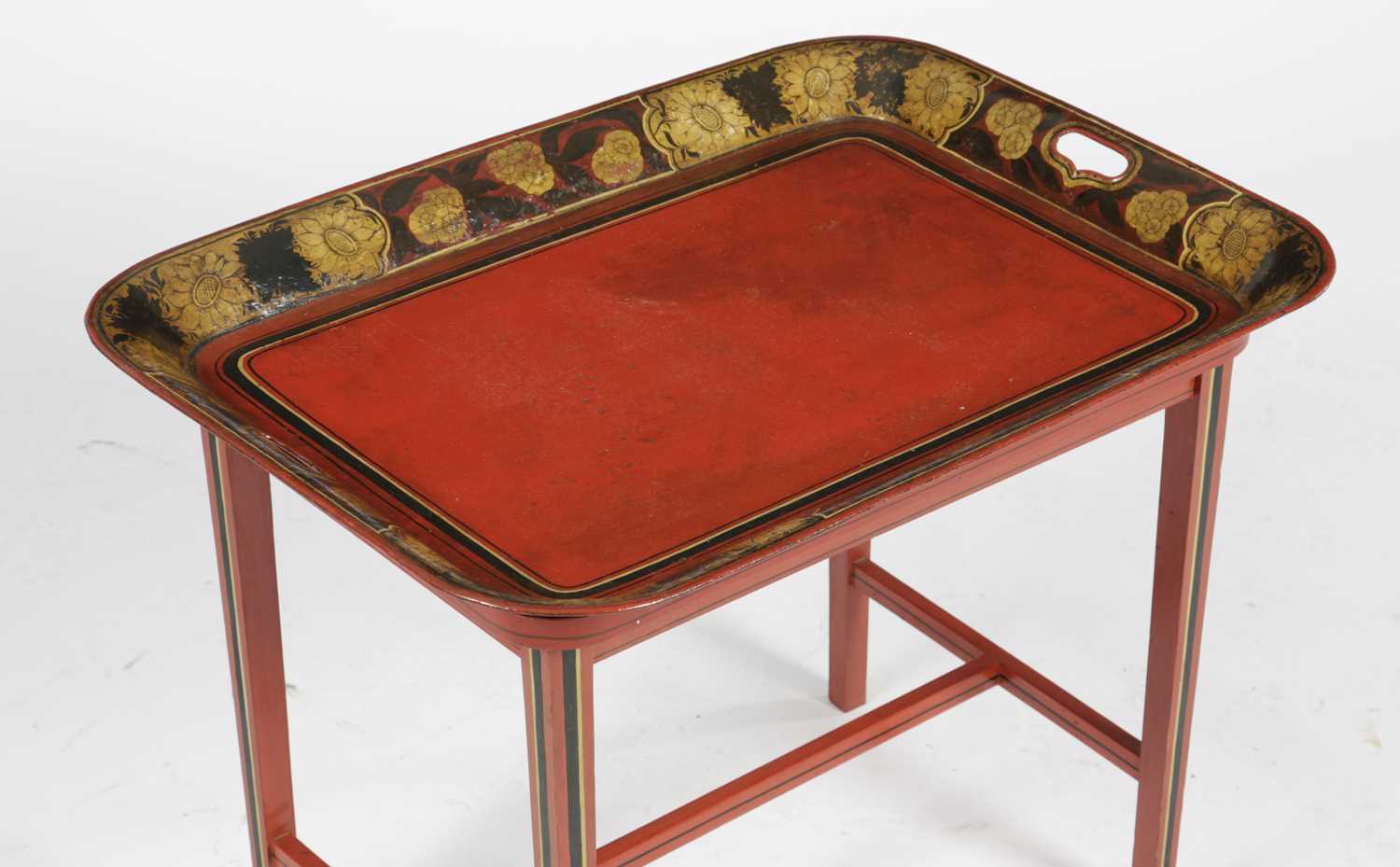 A REGENCY RED TÔLE PEINTE TRAY TABLE EARLY 19TH CENTURY AND LATER painted with a band of flowers and - Image 2 of 3