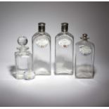 A PAIR OF GLASS AND SILVER PLATED DECANTERS AND COVERS 19TH CENTURY of shouldered rectangular