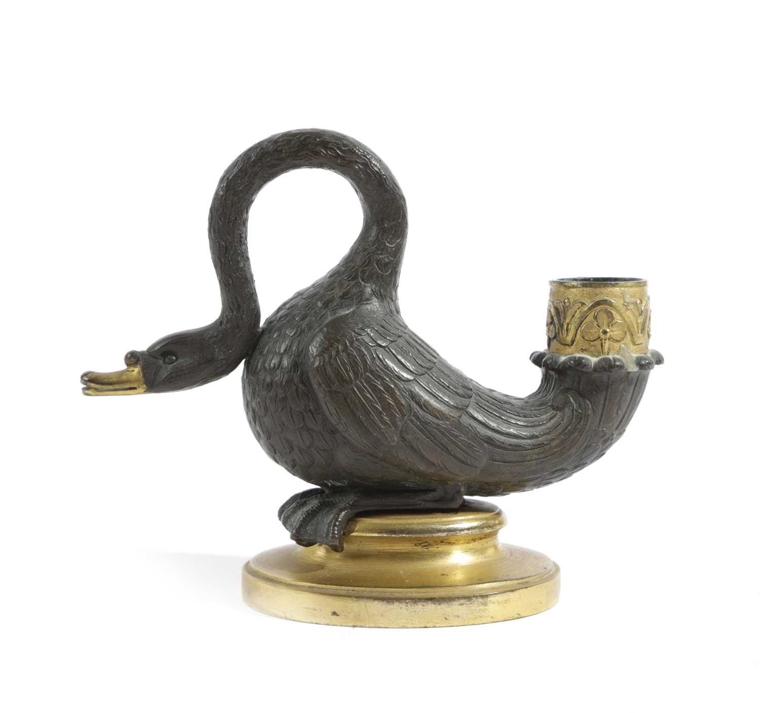 A REGENCY GILT AND PATINATED BRONZE SWAN CHAMBERSTICK EARLY 19TH CENTURY the nozzle decorated with
