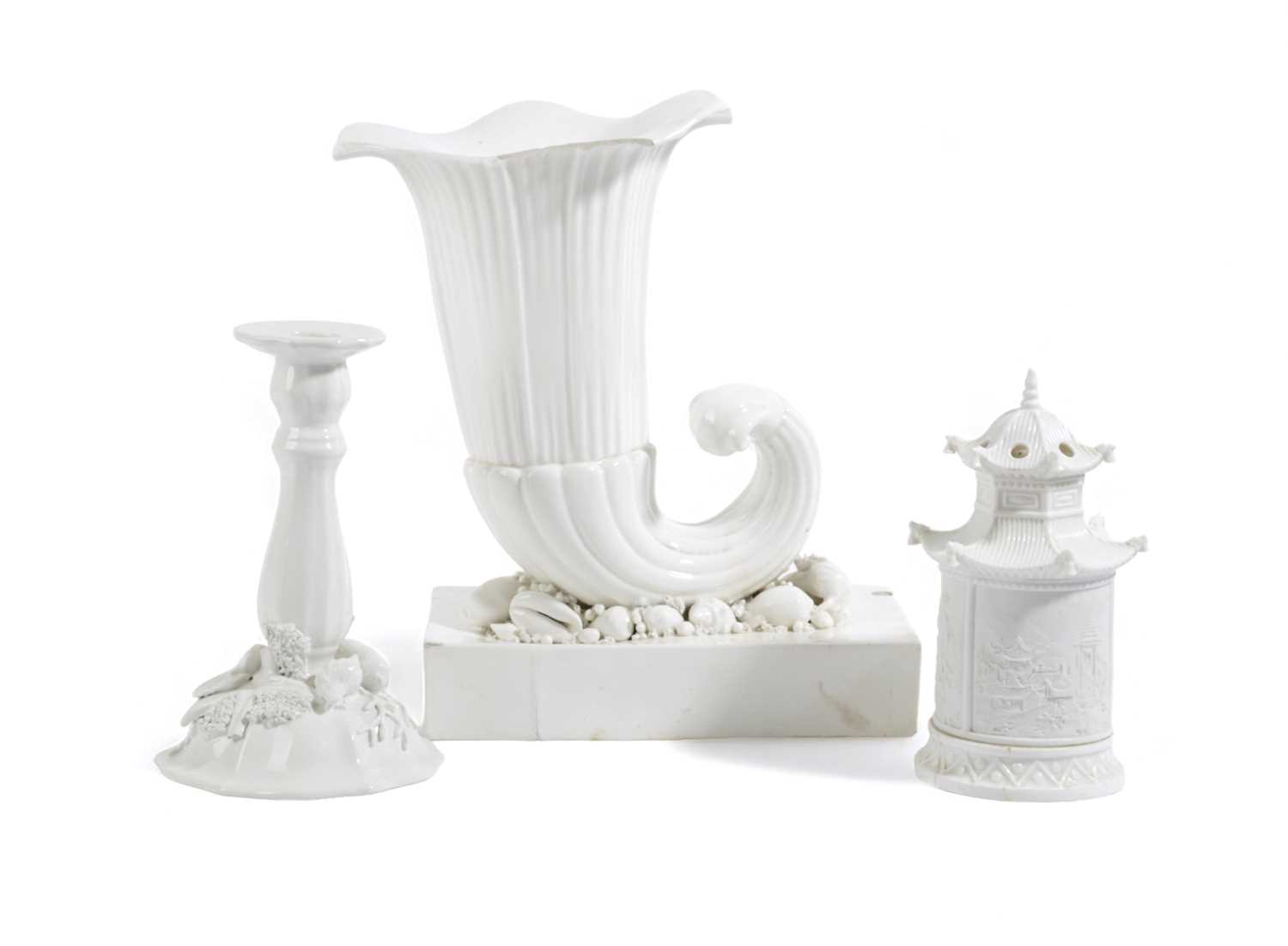 A LARGE PORCELAIN CORNUCOPIA VASE 19TH CENTURY in white, on a bed of shells and a rectangular