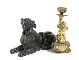 A FRENCH PATINATED METAL GRAND TOUR SPHINX MID-19TH CENTURY modelled recumbent, together with a gilt