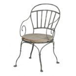 A VICTORIAN PAINTED WROUGHT IRON GARDEN ARMCHAIR 19TH CENTURY with scroll arms and a solid wood seat