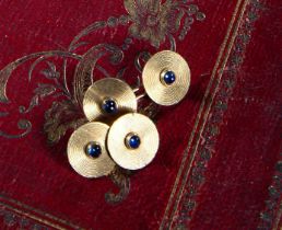 A PAIR OF SAPPHIRE AND GOLD CUFFLINKS BY CARTIER each disc set with a cabochon sapphire within