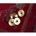 A PAIR OF SAPPHIRE AND GOLD CUFFLINKS BY CARTIER each disc set with a cabochon sapphire within