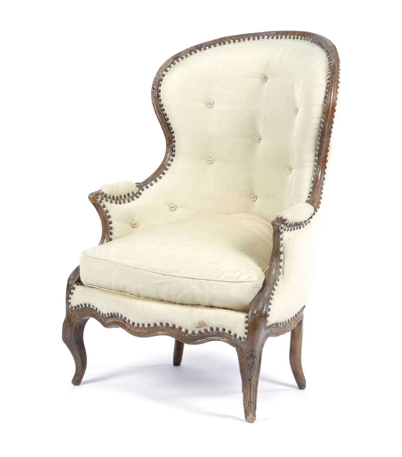 AN ITALIAN WALNUT BERGÈRE 18TH CENTURY with later brass studded upholstery, the moulded frame on