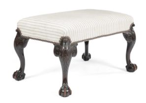 A MAHOGANY STOOL IN GEORGE II STYLE , LATE 19TH CENTURY the stuffed-over seat on leaf carved
