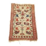 A MELAS RUG WEST ANATOLIA, C.1900 the cream field with a stylised tree of life enclosed by crimson