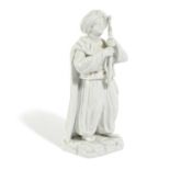 A LARGE CONTINENTAL PORCELAIN FIGURE OF A SULTAN 19TH CENTURY standing on a rocky base and holding a