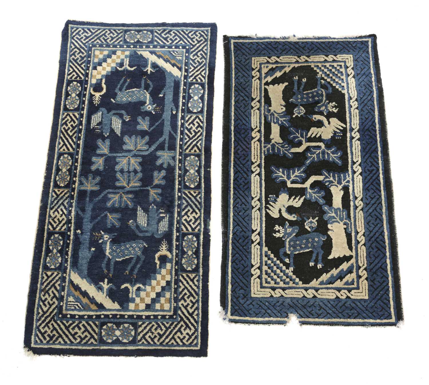 A NINGXIA RUG NORTH CHINA, C.1920 the deep indigo field with trees, animals and birds enclosed by