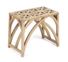 AN ARTS AND CRAFTS OAK STOOL EARLY 20TH CENTURY the interlaced top on arched Gothic supports 35.